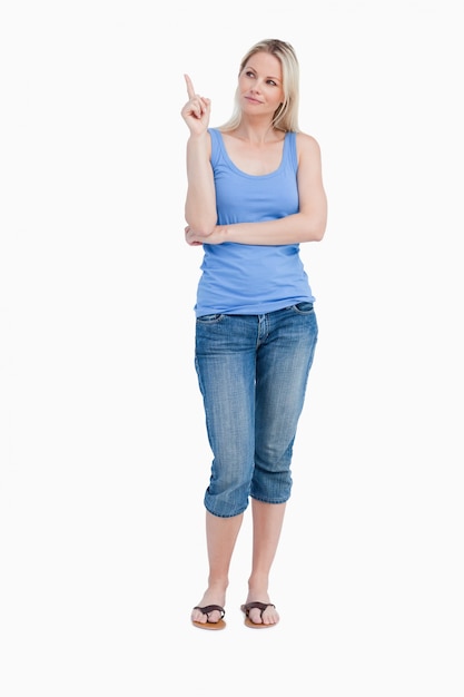 Blonde woman raising her finger while crossing arms