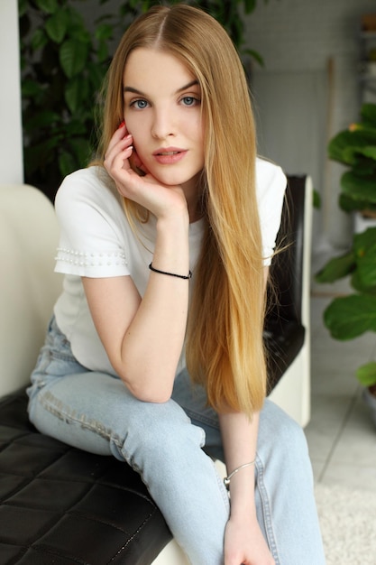 Blonde woman sitting on sofa