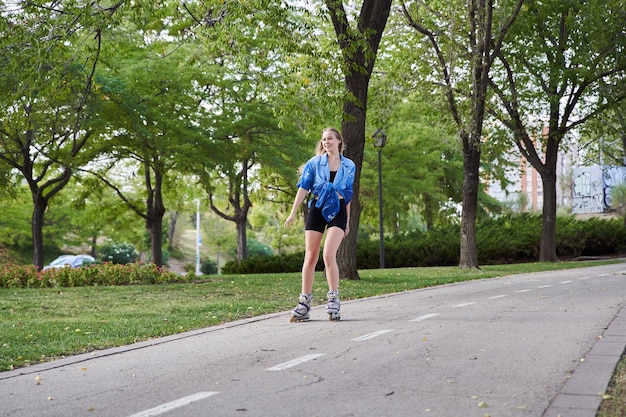 Blonde woman skateboarding with inline skates