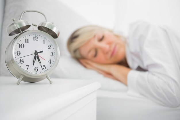 Blonde woman sleeping in bed