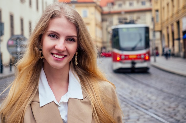 Blonde woman stand in bus stop and waiting trolley in Prague sity Chezh