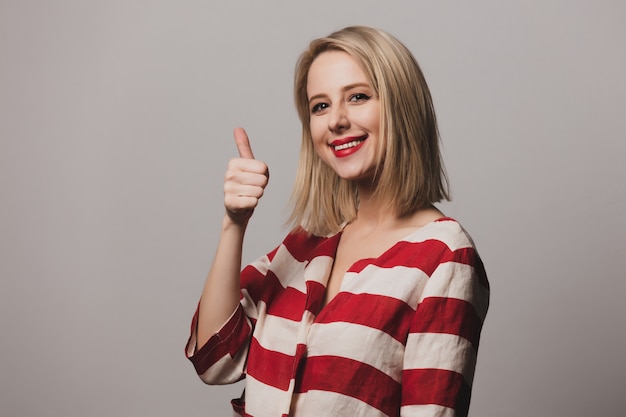 Blonde woman in striped jacket