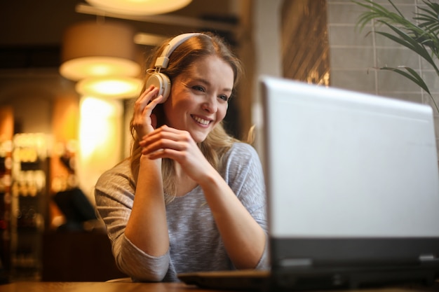 Blonde woman watching a movie online