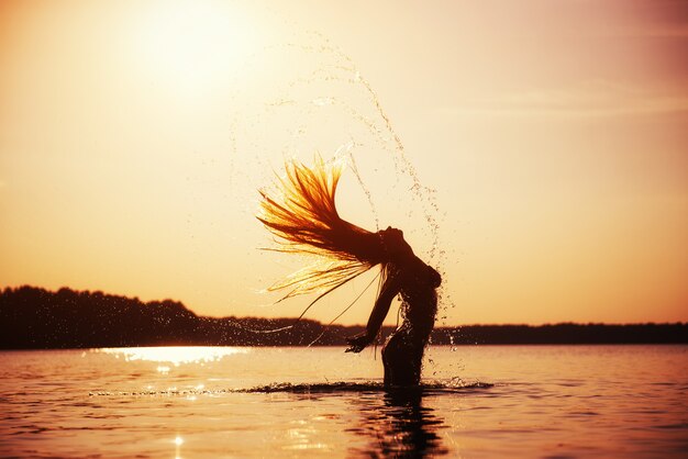 Blonde woman on water background