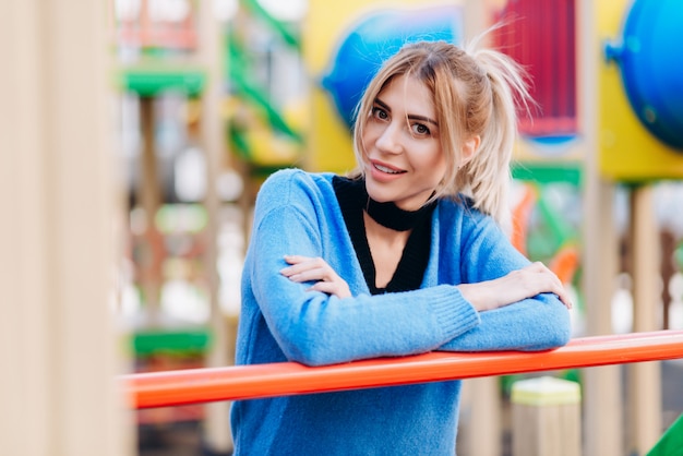 Blonde woman wearing in blue sweater standing