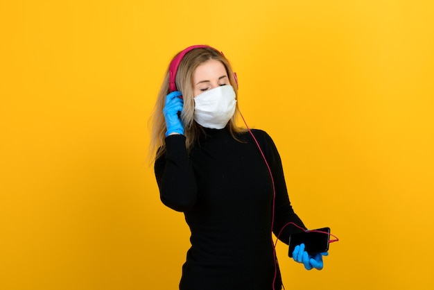 Blonde woman wearing a protective mask and gloves