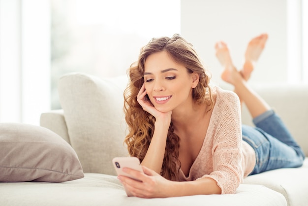 blonde woman with curly hair at home