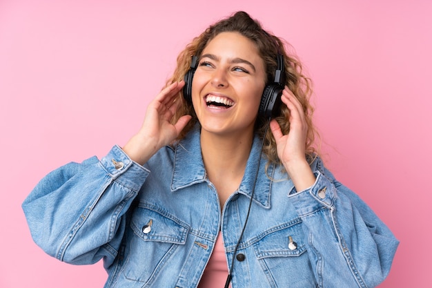 blonde woman with curly hair isolated listening music and singing