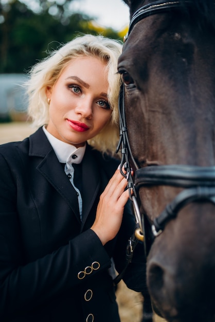 Blonde woman with horse, horseback riding