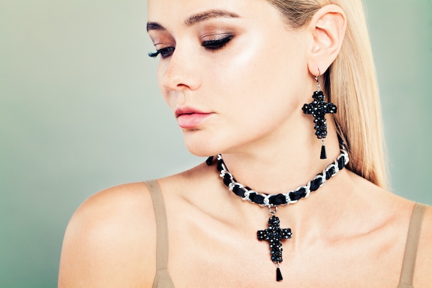 Blonde Woman with Jewelry and Makeup. Face Closeup