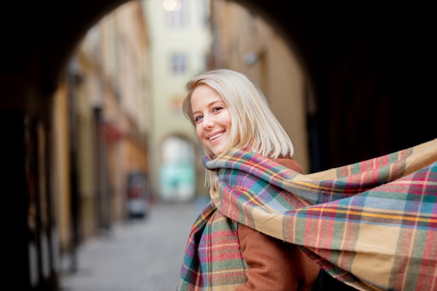 Blonde woman with scarf in old town of Wroclaw