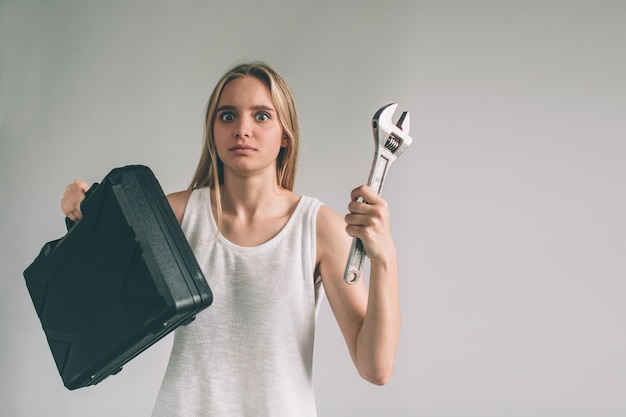 Blonde woman with tools isolated on white