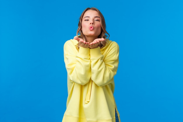 Blonde woman in a yellow sweatshirt