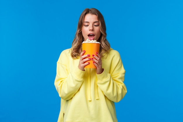 Blonde woman in a yellow sweatshirt