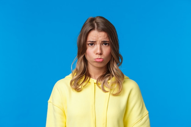 Blonde woman in a yellow sweatshirt