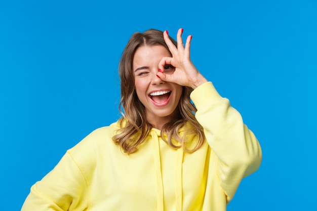 Blonde woman in a yellow sweatshirt