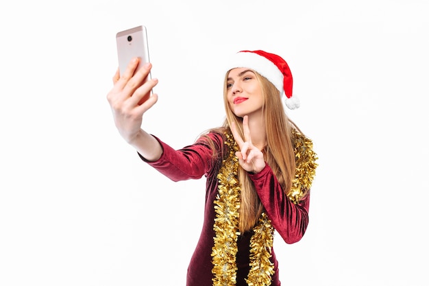 Blonde young woman wearing a Santa hat and tinsel