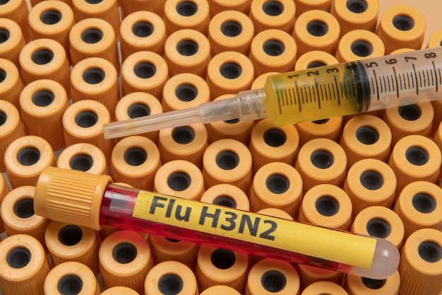 Blood collection tubes labeled "Flu H3N2" symbolizing the flu epidemic