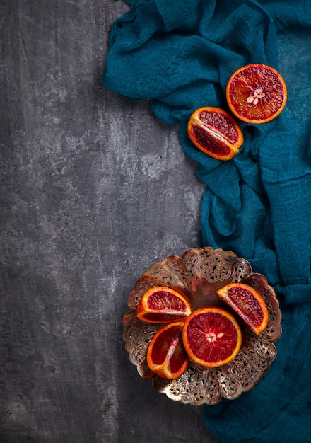 Blood Orange in a metal Plate with a knife