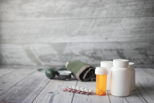 Blood pressure machine and medical pill on table