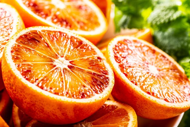 Foto arance siciliane di sangue tagliate con melissa fresca da vicino