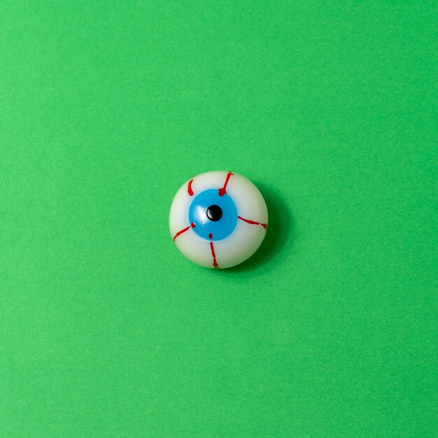 Bloody eyeball on a vivid green background