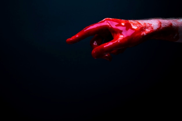 Bloody hand against a dark background halloween horror concept