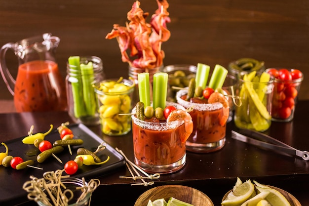 Bloody mary cocktail bar with variety of garnishes.