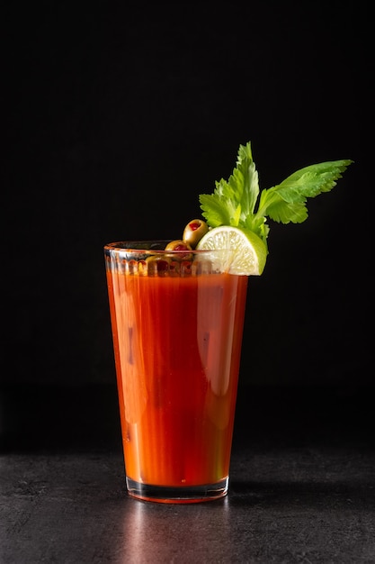 Bloody Mary cocktail in glass on black background