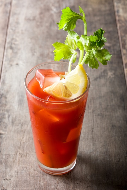 Bloody mary cocktail in glass on wooden table