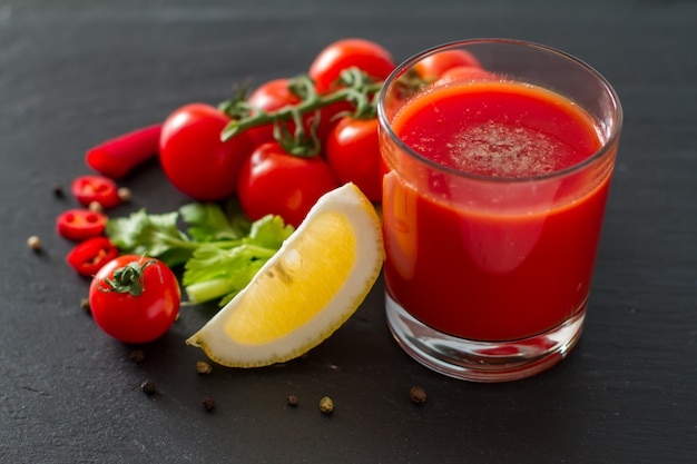 Bloody Mary ingredients on dark stone background