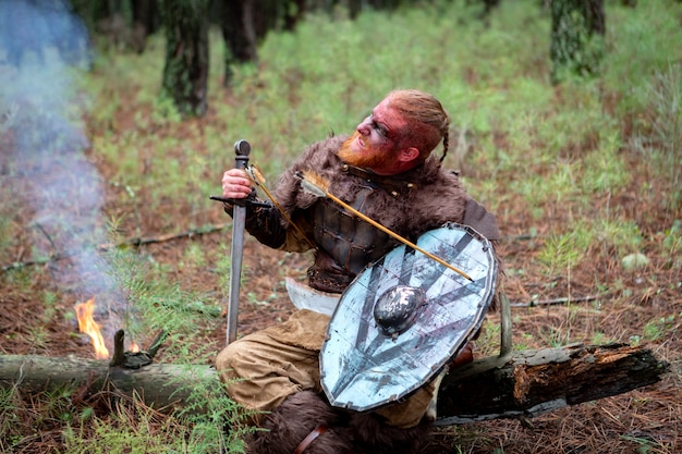 Кровавый настоящий викинг со стрелой на щите