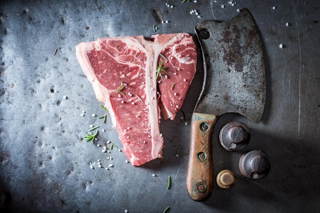 Bloody red steak with salt and rosemary