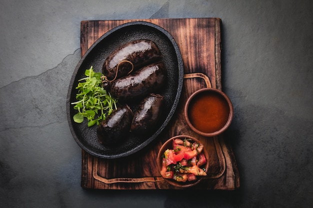 Bloody sausages on an iron plate