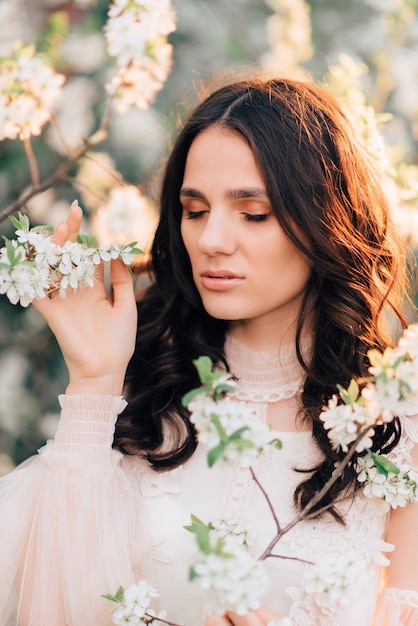 A blooming garden with a beautiful young girl in it