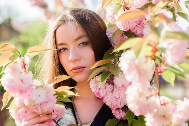 花臭アレルギースキンケアとスパ桜の肌の女の子のための自然化粧品桜の木が咲く春の花の自然な夏の美しさの女性あなたはとても美しいです