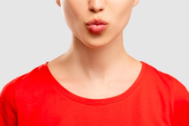 Воздушный поцелуй посылает любовь женщине в красной футболке