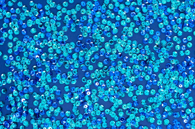 Blue abstract background, texture with round blue sequins. Christmas or party creative mock up.