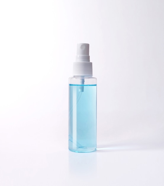Blue alcohol bottle spray isolated with clipping path. Covid-19 concept.