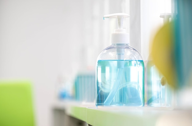 Blue alcohol gel bottle placed on the table to serve customers within a bank measures to prevent the spread of respiratory viral disease