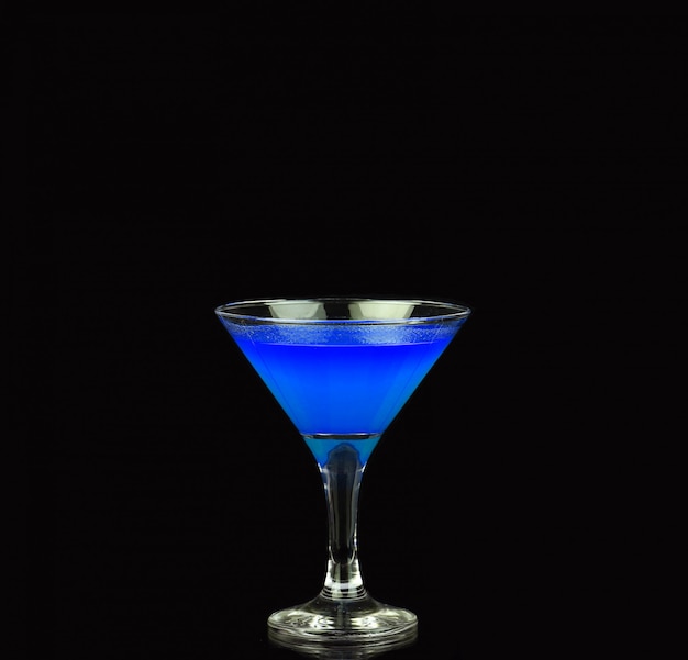 Blue alcoholic cocktail on the black