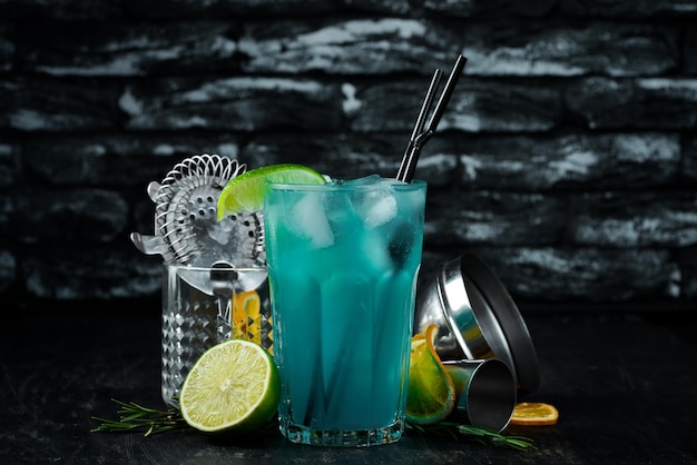 Blue Alcoholic Cocktail On a wooden background Top view Free copy space