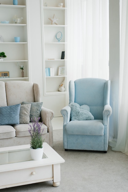 Blue armchair in the interior of a bright living
