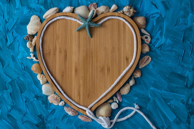 on a blue background blue shells and a frame in the shape of a heart 