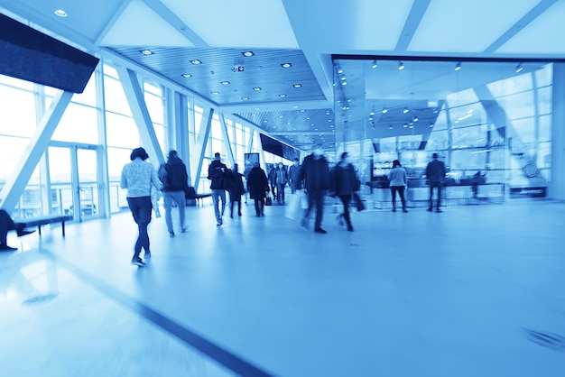 blue background blurred movement of people shopping mall