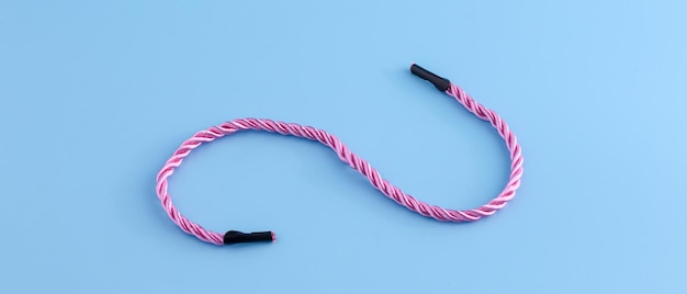 Blue background picture with a pastel pink rope