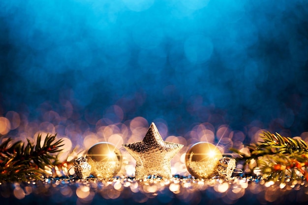 A blue background with christmas decorations and a star on the top