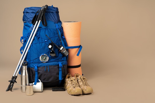 Photo blue backpack and hiking boots. mountain gear close up