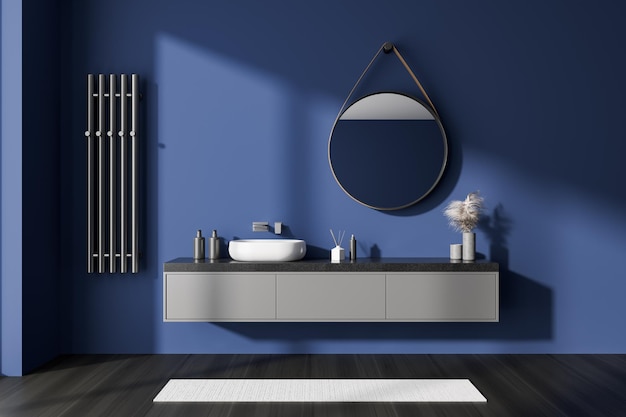 Blue bathroom interior with sink and mirror accessories on drawer