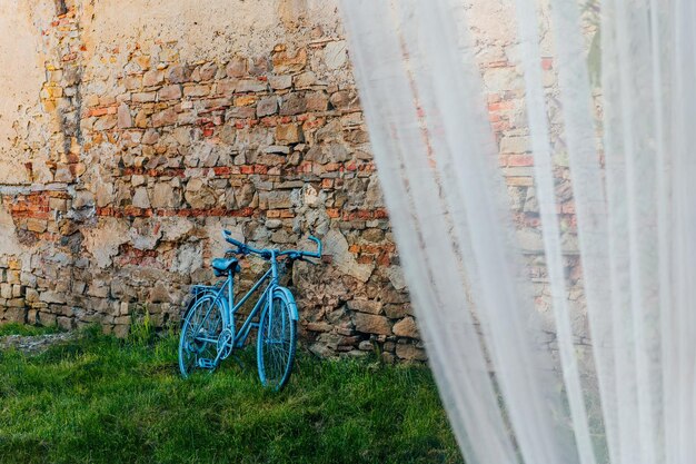 Foto bicicletta blu appoggiata al muro